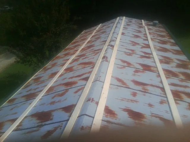 Rusted metal roof panels with new wood purlins before replacement — Storm Damage Roof Repair in Hagaman by Roofing Brothers